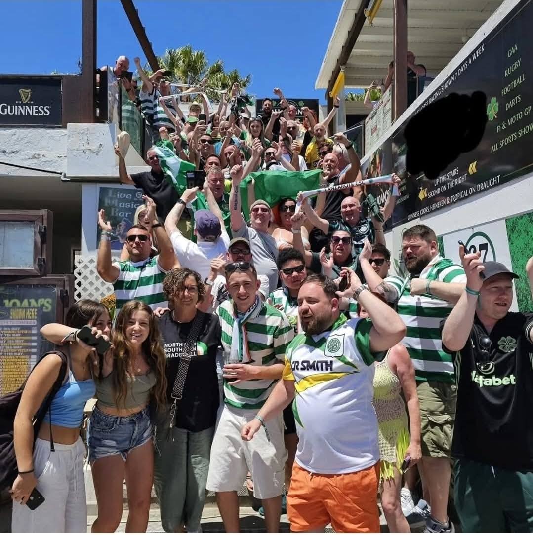 Celtic supporters celebrating on the stairs at Bar 67